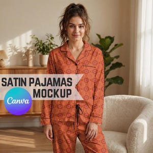 May include: Satin pajamas set in a warm orange hue with a geometric pattern. The long-sleeved top and pants feature black trim and a drawstring waist. The text "SATIN PAJAMAS MOCKUP" is displayed on the image.