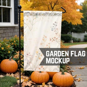 May include: A white garden flag with a floral pattern hangs on a black metal pole. The flag is in front of a brick wall and a pathway with fallen leaves. The text "GARDEN FLAG MOCKUP" is printed on the flag.