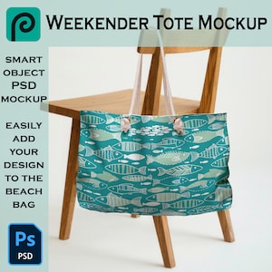 May include: A teal blue tote bag with a white fish pattern on a wooden chair. The bag has white rope handles and wooden toggles. The text "WEEKENDER TOTE MOCKUP" is at the top of the image.