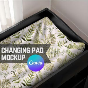May include: A white changing mat with a green leafy pattern. The mat is on a black changing table. The text "CHANGING PAD MOCKUP" and the Canva logo are visible.