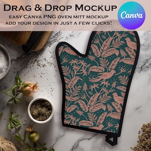 May include: An oven mitt with a dark teal background and a pattern of pink leaves and birds. The mitt has a black trim and a loop for hanging. Text on the image reads "Drag & Drop Mockup" and "Easy Canva PNG oven mitt mockup".