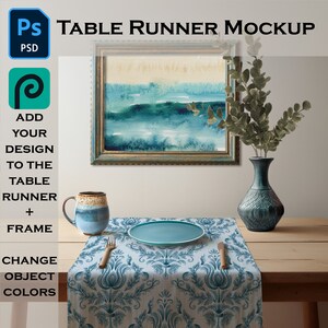 May include: A mockup of a table runner with a blue and white damask pattern. The runner is laid out on a wooden table with a blue plate, a mug, and a vase with green leaves. A framed painting with a blue and white watercolor design hangs on the wall behind the table.