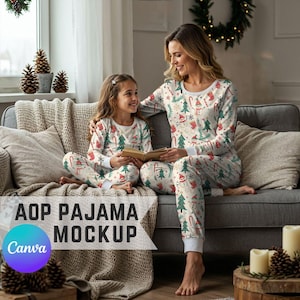 May include: Matching Christmas pajamas with a festive pattern of snowmen, Christmas trees, and candy canes. The pajamas are white with red and green accents. A mother and child are sitting on a gray couch, wearing the pajamas. The text "AOP PAJAMA MOCKUP" is visible.