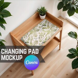 May include: A wooden changing table with a white changing pad featuring a green leafy pattern. The changing pad is on top of the table, which has a lower shelf.