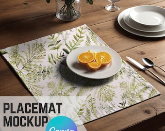 May include: A white placemat with a green leafy pattern and a plate of orange slices on top. The placemat is on a wooden table with a glass of water and a plate of white dishes.
