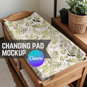 May include: A wooden changing pad with a white changing pad cover featuring a green leafy pattern. The text "CHANGING PAD MOCKUP Canva" is visible on the changing pad.