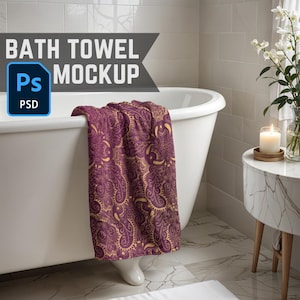 May include: A white bathtub with a purple and gold patterned bath towel draped over the edge. The towel has a paisley design. The bathroom has white tile walls and a small side table with a candle on it.