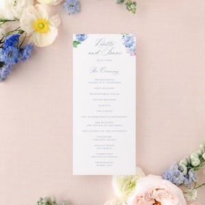 May include: A wedding ceremony program with a watercolor illustration of blue hydrangeas and the names Lisette and Isaac. The program lists the order of the ceremony, including the processional, readings, and recessional.