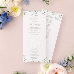 May include: Wedding ceremony program with a green watercolor floral design. The program lists the order of events for the ceremony, including the processional, readings, and the liturgy of the Eucharist. The program also includes the names of the bride and groom, Livette and Isaac, and the date of the wedding, July 22nd.