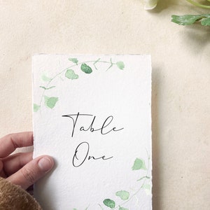 garden table numbers eucalyptus, printed table number cards wedding, handmade paper table numbers greenery, botanical table number hand torn