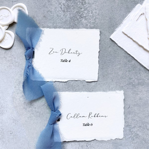 dusty blue place cards with ribbon, flat place cards with meal choice, deckled edge place cards with table number, handmade paper placecard
