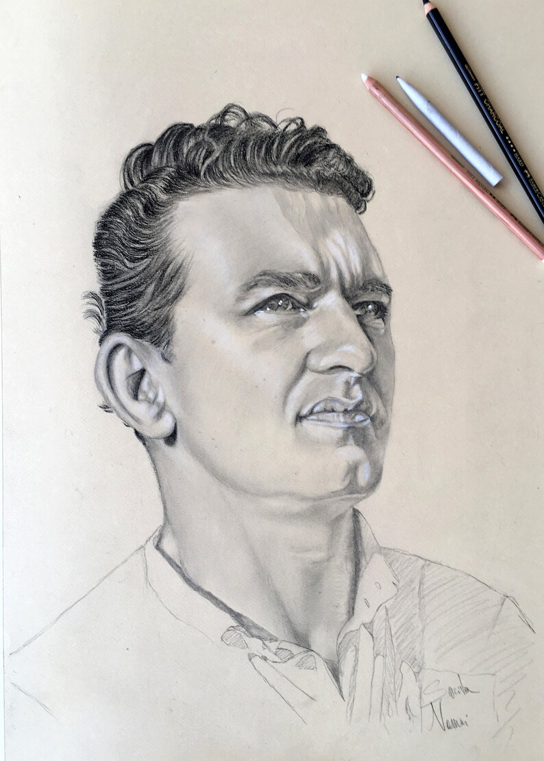 May include: A black and white pencil drawing of a man's face. The man has short, dark hair and is looking up and to the right. The drawing is signed "Elvira Vanni".