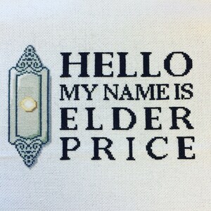 Puede incluir: Arte de punto de cruz sobre tela blanca. El texto dice "HELLO MY NAME IS ELDER PRICE" en hilo negro. Un dise&ntilde;o decorativo, verde claro y azul, est&aacute; en el lado izquierdo del texto.