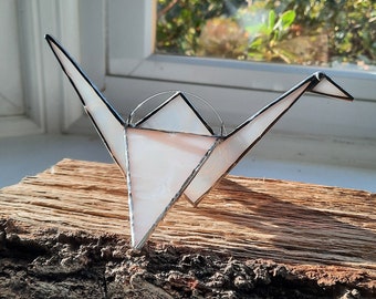 A 3D Stained Glass Origami Crane brings peace, good fortune & get well wishes. This hanging bird can also sit on a window ledge or bookcase.