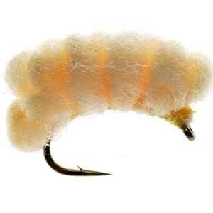 May include: Close-up of a fishing fly with a fluffy, cream-colored body and a curved black hook. The fly has orange accents and is designed to mimic an insect. Ideal for fly fishing.