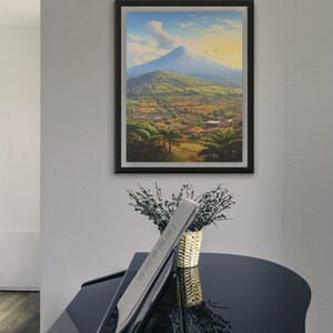 May include: A framed painting of a mountain landscape with a village in the foreground. The mountain is blue and the sky is a light blue with white clouds. The village is green and brown with small houses and trees.