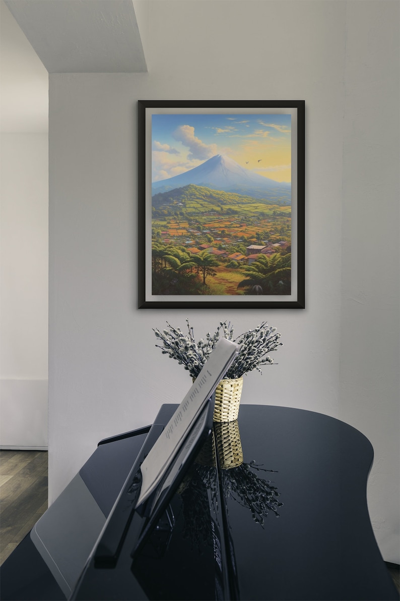 May include: A framed painting of a mountain landscape with a village in the foreground. The mountain is blue and the sky is a light blue with white clouds. The village is green and brown with small houses and trees.