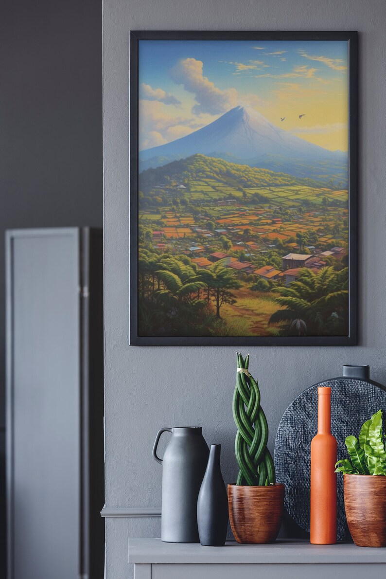 May include: A framed painting of a mountain landscape with a village in the foreground. The mountain is blue and white, and the sky is blue with white clouds. The village is green and brown, with houses and trees.