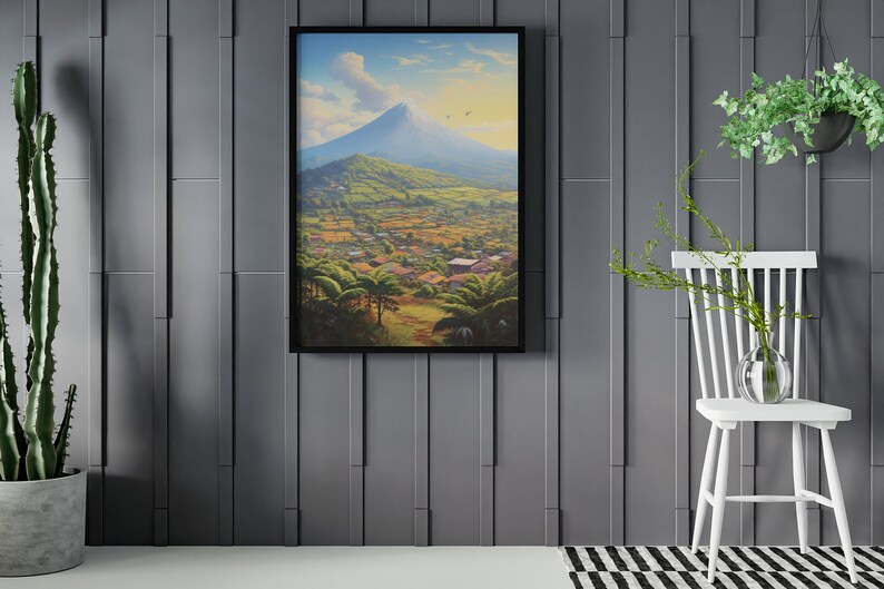 May include: A framed painting of a mountain landscape with a village in the foreground. The painting is set against a gray wall with a potted plant and a white chair to the right.