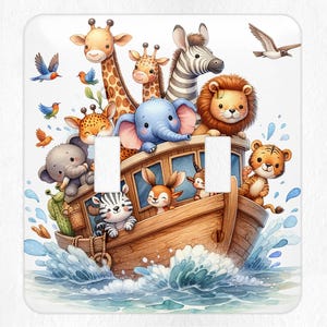 May include: A white light switch cover featuring a watercolor illustration of Noah's Ark. The ark is filled with cartoon animals, including giraffes, elephants, lions, and zebras. Blue water surrounds the ark, and birds fly in the sky.