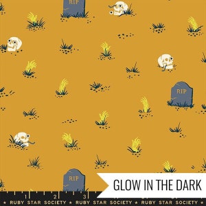 May include: A yellow fabric with a repeating pattern of skulls, hands, and tombstones with the text "RIP". The fabric glows in the dark.