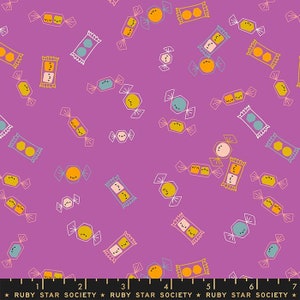May include: Purple fabric with a repeating pattern of colorful candy and wrapped candy. The candy is drawn in a cartoon style with smiling faces.