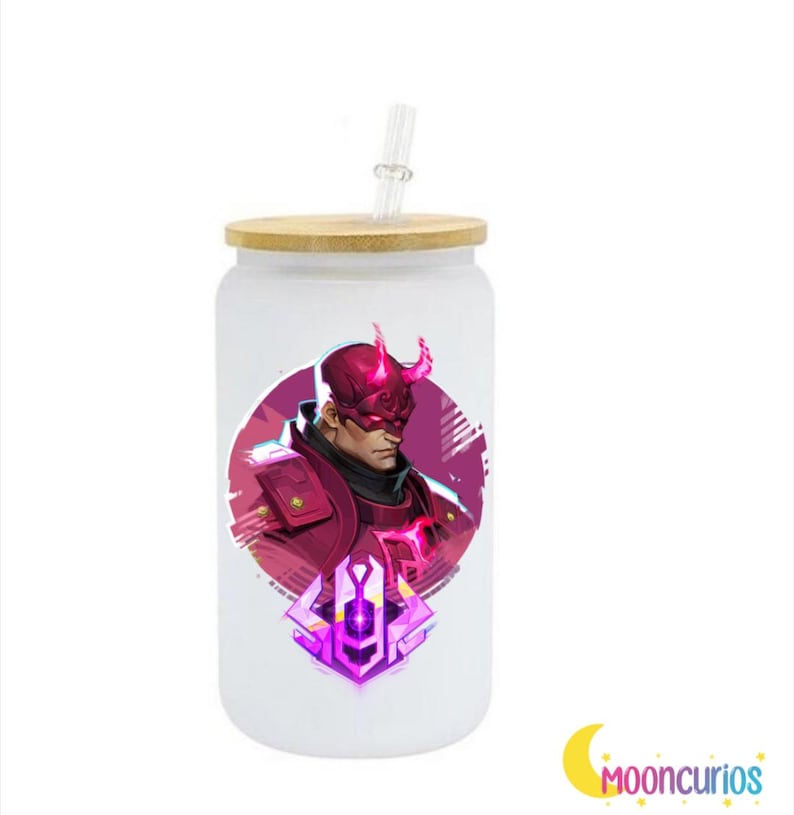 May include: A white glass tumbler with a bamboo lid and a clear straw. The tumbler features a graphic of a character in a red and purple color scheme. The character has a mask and horns. The logo "Mooncurios" is in the bottom right corner.