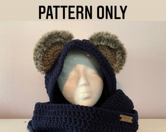 May include: Crochet pattern for a hooded scarf with bear ears. The scarf is navy blue and the ears are brown with faux fur. The pattern is for a finished product, not the product itself. The text "PATTERN ONLY" is at the top of the image and the text "THIS IS NOT A FINISHED PRODUCT" is at the bottom of the image.