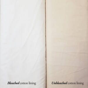 May include: Close-up of two fabric swatches, one bleached white cotton lining and one unbleached natural cotton lining.
