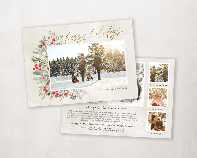 May include: A Christmas card with a watercolor wreath of red berries and green leaves. The card features a photo of a family in a snowy forest. The text "happy holidays 21" is written in gold script. The back of the card has a message about the family's year in review.
