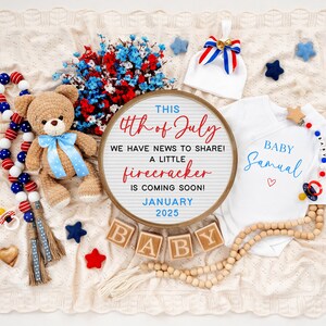 May include: A white onesie with the text "Baby Samual" in blue lettering and a red heart. A round sign with the text "This 4th of July we have news to share! A little firecracker is coming soon! January 2025". A teddy bear wearing a blue bow tie and a red, white, and blue garland.