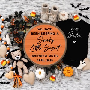 May include: A Halloween-themed baby announcement with a sign that reads "We have been keeping a spooky little secret brewing until April 2025". A black onesie with the text "Baby Salem" is also included in the image.