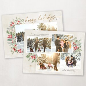 May include: A Christmas card with a wintery scene featuring a family of four in a snowy forest. The card has a wreath with red berries and green leaves around the edges. The text "happy holidays 2021" is written in gold script at the top of the card. The text "Wishing you & your family a holiday season filled with love, health & happiness" is written in black script at the bottom of the card.