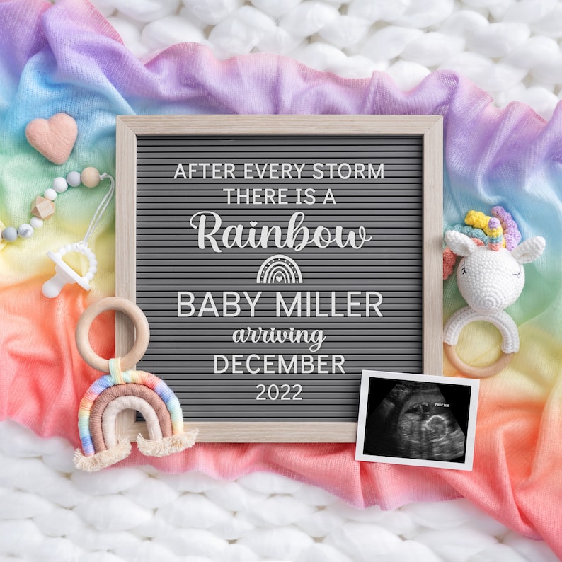 May include: A letter board with the message "After every storm there is a rainbow Baby Miller arriving December 2022". The board is surrounded by a rainbow coloured blanket, a unicorn toy, and a wooden rainbow.