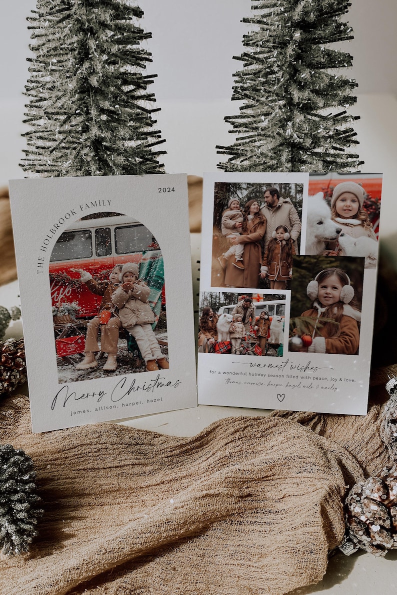 May include: A Christmas card with a photo of a family in front of a vintage van. The card has a white background with a brown arch and the text "The Holbrook Family 2024" at the top. The text "Merry Christmas" is written in cursive below the photo. The names "james, allison, harper, hazel" are listed below the greeting. The card also includes the text "Warmest wishes for a wonderful holiday season filled with peace, joy & love. The Holbrook Family" with a heart symbol.