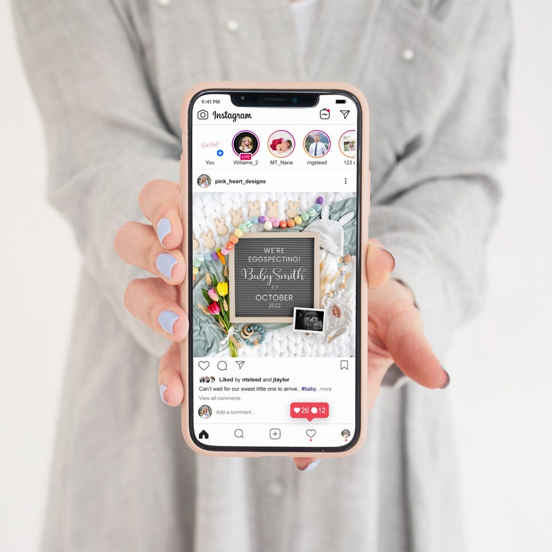 May include: A phone screen displaying an Instagram post announcing a pregnancy with the text "We're Eggspecting! Baby Smith October 2023". The post features a chalkboard sign with the announcement, a baby rattle, a knitted blanket, and a sonogram photo.