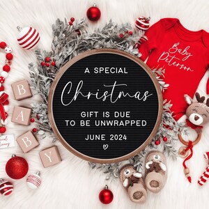 May include: A black letter board with the text "A Special Christmas Gift is Due to be Unwrapped June 2024" surrounded by red and white Christmas decorations, including ornaments, a candy cane, and a baby onesie with the text "Baby Peterson".