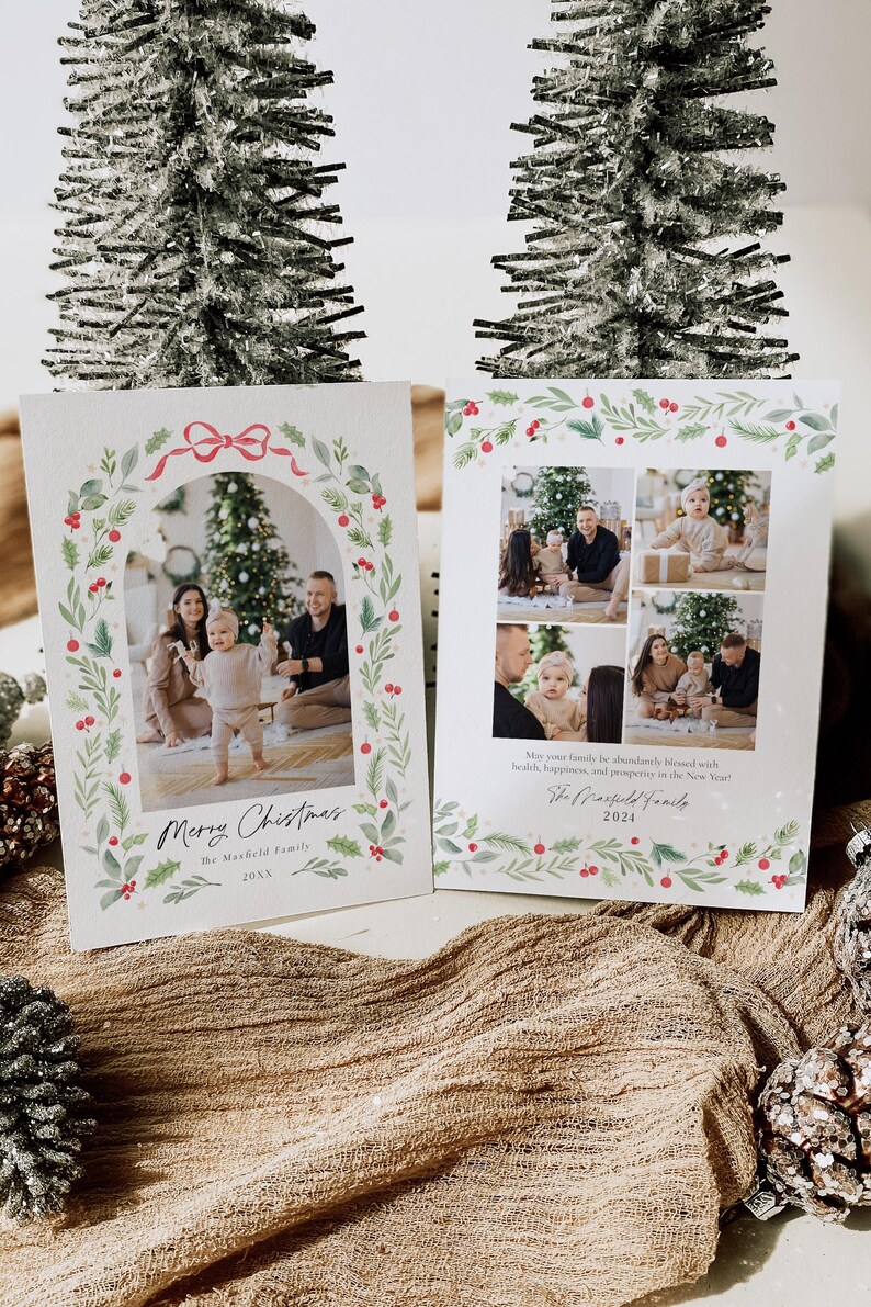 May include: A Christmas card with a watercolor wreath border and a family photo inside. The card says "Merry Christmas" and "The Mansfield Family" with the year 20XX. The card also includes a message wishing the recipient a happy holiday season.