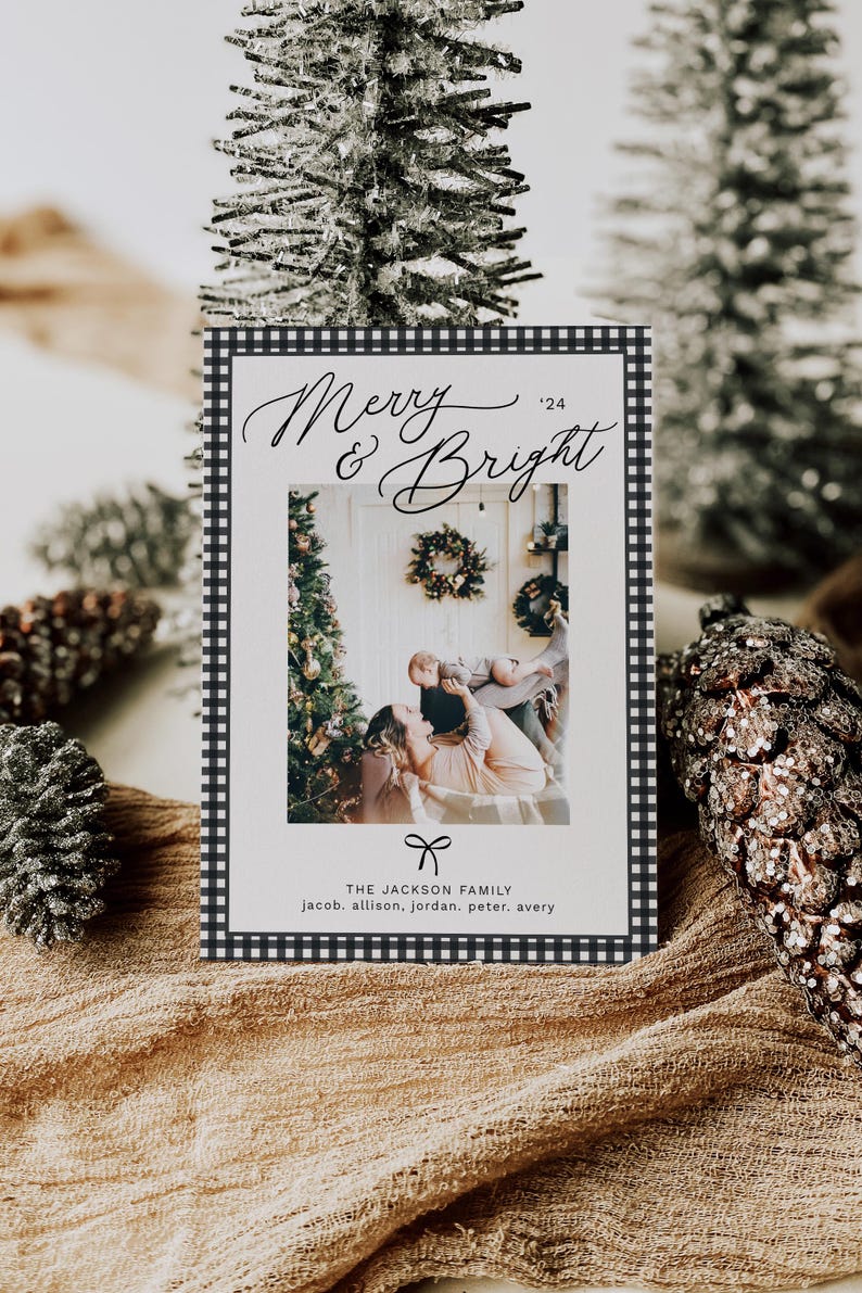 May include: A black and white checkered Christmas card with the text "Merry & Bright '24" in cursive script. The card features a photo of a family with a Christmas tree in the background. The text "THE JACKSON FAMILY jacob. allison, jordan. peter. avery" is printed at the bottom of the card.