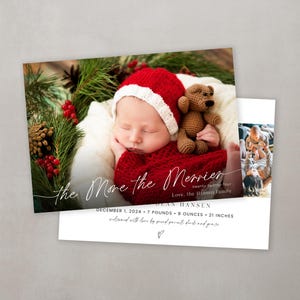 May include: A Christmas card with a photo of a baby wearing a red Santa hat and holding a brown teddy bear. The card reads "The More the Merrier" and "Love, the Hansen Family". The baby was born on December 1, 2024, and weighed 7 pounds and 8 ounces. The card also includes the text "twenty twenty-four".