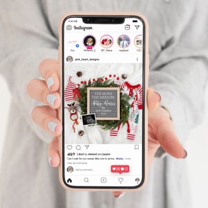 May include: A smartphone displays a pregnancy announcement on Instagram. The announcement features a letter board with the text "THE MORE THE MERRIER Baby Harris SEPTEMBER 2023" surrounded by Christmas decorations and baby clothes.