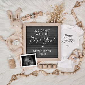 May include: A pregnancy announcement featuring a letter board with the text "WE CAN'T WAIT TO MEET YOU! SEPTEMBER 2023", a baby onesie, ultrasound image, wooden blocks spelling "BABY", and baby toys. The onesie says "BABY Smith".