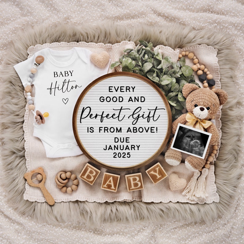 May include: A wooden sign with the text "Every good and perfect gift is from above! Due January 2025" surrounded by baby items including a white onesie, a teddy bear, wooden blocks spelling "BABY", and a sonogram photo.