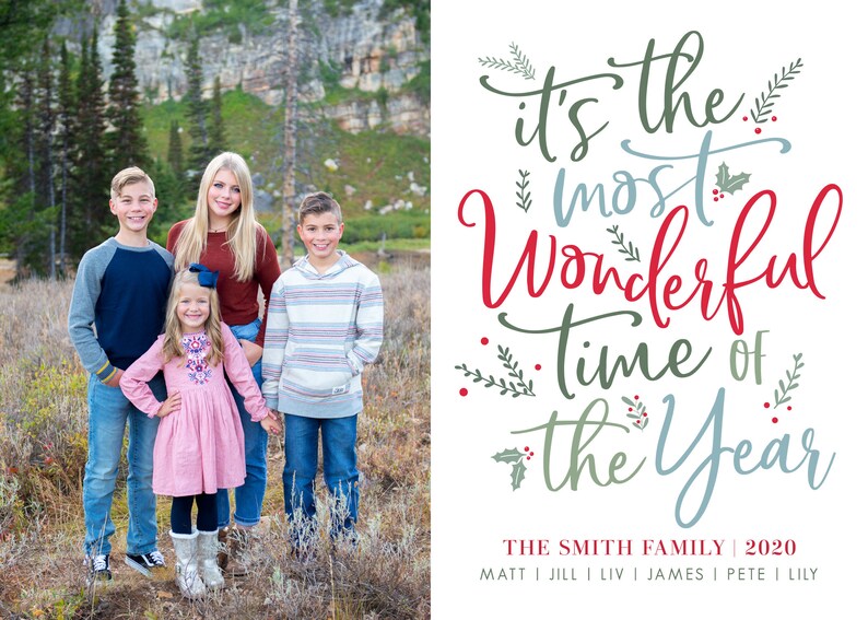 May include: A Christmas card featuring a family of five standing in a snowy forest. The card has the text "It's the most wonderful time of the year" in red, blue, and green lettering. The family's names are listed below the text: "The Smith Family | 2020".