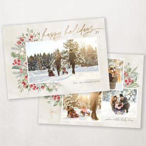 May include: A Christmas card with a watercolor wreath of greenery and red berries. The card features two photos of a family in winter. The text "happy holidays 2021" is written in gold script.