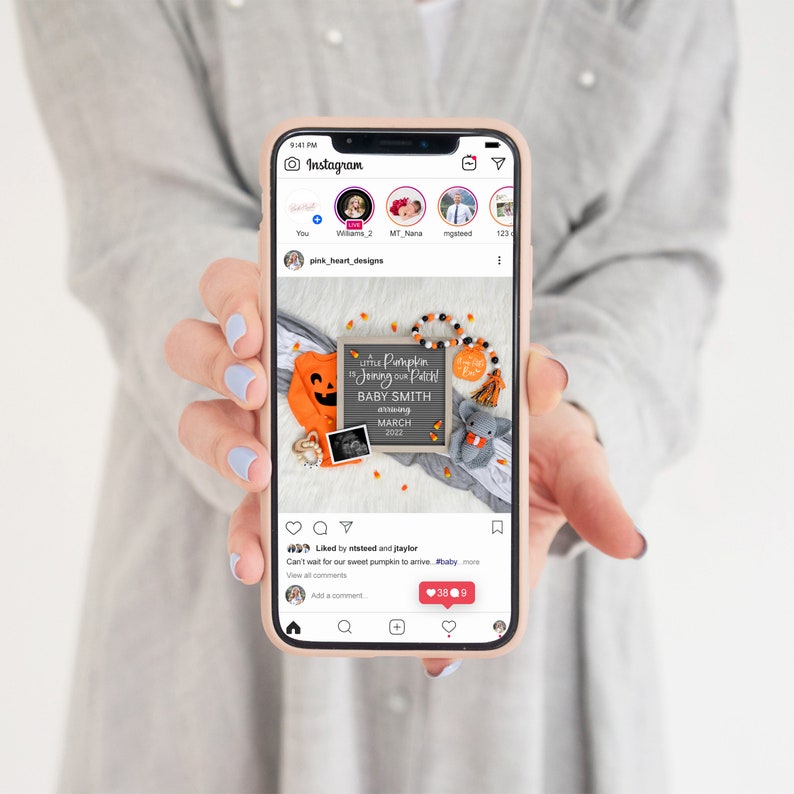 May include: A phone screen displaying an Instagram post with a photo of a baby announcement. The announcement features a chalkboard sign with the text "Little Pumpkin in Joining our Patch! Baby Smith Arriving March 2022". The photo also includes a pumpkin-themed onesie, a small stuffed elephant, and a garland of candy corn.