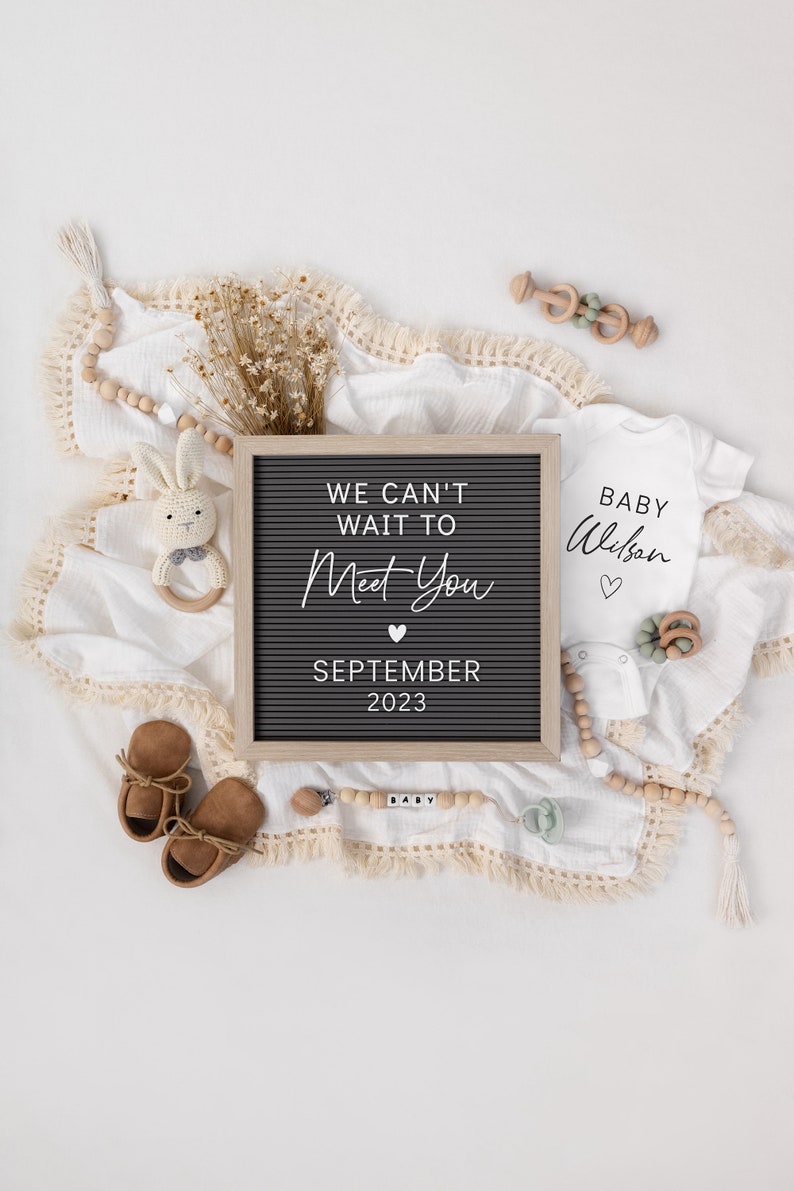 Puede incluir: Anuncio de beb&eacute; en tonos neutros con una pizarra de letras que dice "We can't wait to meet you September 2023". La imagen incluye un body blanco, zapatos de beb&eacute;, un chupete y un sonajero de conejito de ganchillo.