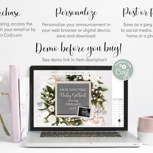 May include: A laptop screen shows a pregnancy announcement: "We're expecting! Baby Gilbert arriving February 2022." The announcement is framed by white flowers and foliage. A pink mug, books, and a vase with flowers are also visible in the image.