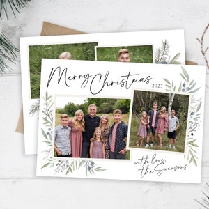 May include: A Christmas card with a watercolor design of green leaves and berries. The card features a family photo with the text "Merry Christmas 2023" and "with love, the Swensons".