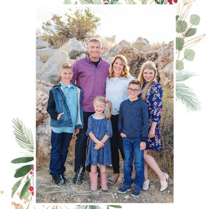 May include: A family of six poses for a photo in front of a rocky landscape. The family is dressed in casual clothing, including jeans, shirts, and dresses. The father is wearing a purple shirt, the mother is wearing a white shirt, and the children are wearing a variety of colors. The family is smiling and looking at the camera.